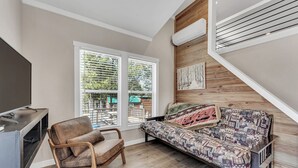 A room with a sofa, a chair, a TV, and a window with blinds. - Indian Point Cabin 4 near Silver Dollar City, Table Rock Lake & Branson (Branson)