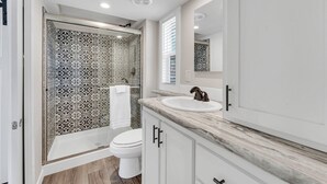 A bathroom with a shower, toilet, and sink. - Indian Point Cabin 4 near Silver Dollar City, Table Rock Lake & Branson (Branson)