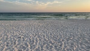 A beach with white sand and gentle waves. - Waterfront views! 3 BR Walk to beach, Pool, Dock (Fort Walton Beach)