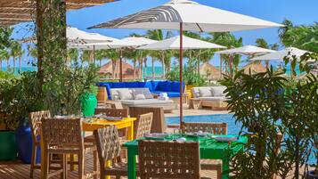 On the beach, white sand, beach cabanas, sun-loungers