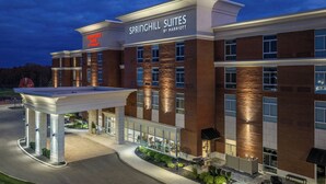 A hotel with a brick facade, large windows, and a well-lit entrance. - Towneplace Suites By Marriott Canfield (Canfield)