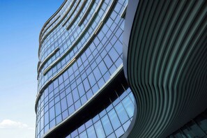 A modern building with a curved facade and large windows.