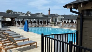 A pool area with lounge chairs and a wooden deck. - EXCEPTIONAL LOCATION - LUXURY VILLA STEPS AWAY FROM THE BEACH AND POOL (Corolla)