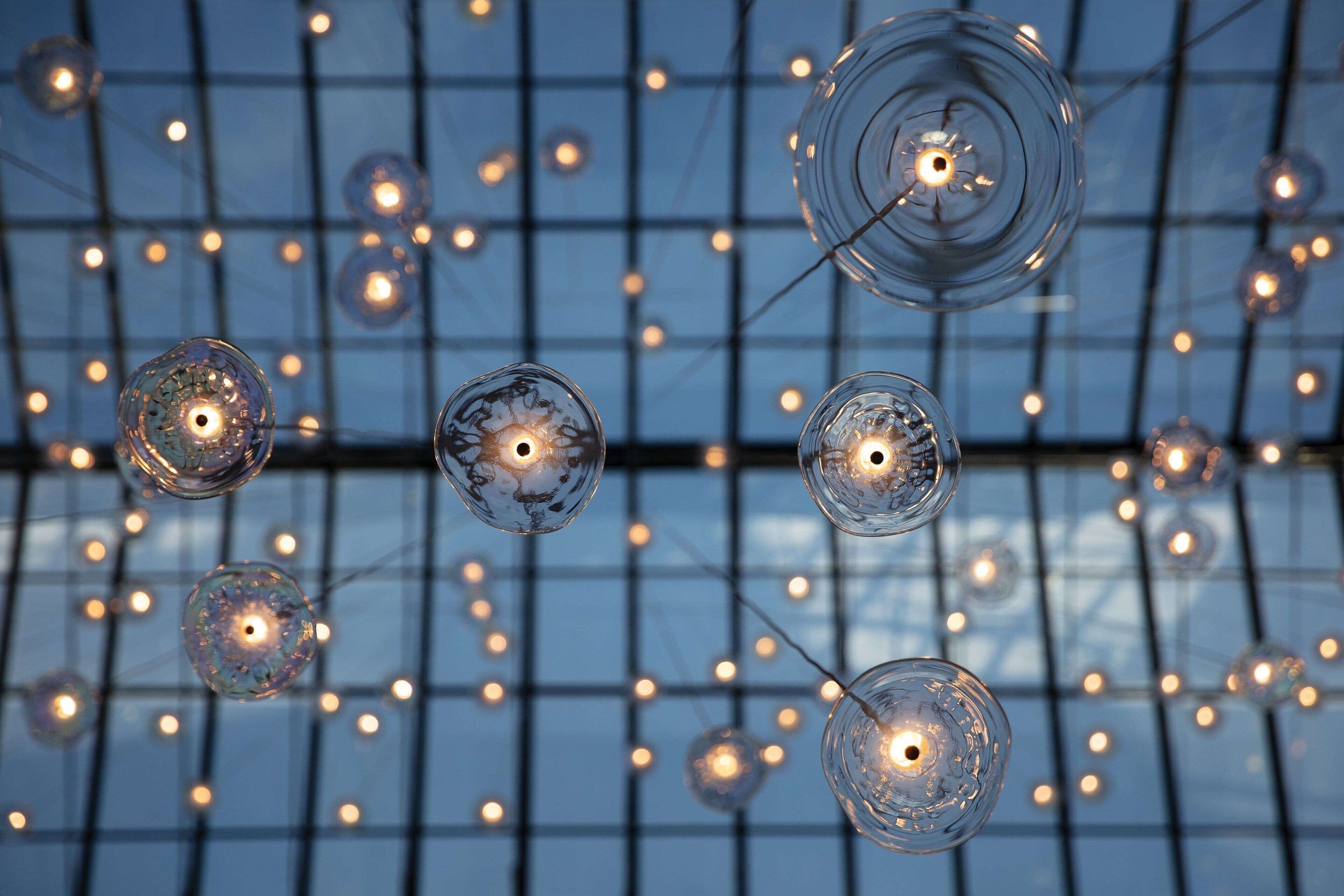 A ceiling with hanging spherical glass light fixtures.