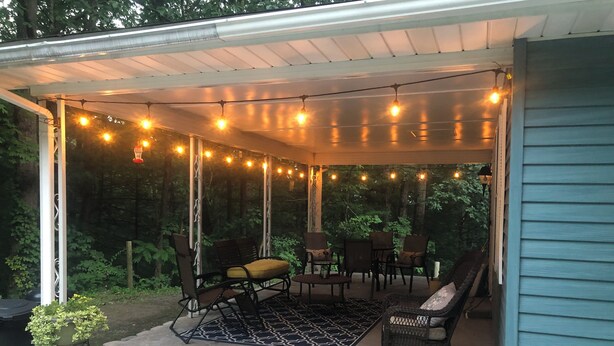 A covered patio with string lights, outdoor furniture, and a concrete floor. - Raystown Lake getaway <br>3 bedroom 2 bath<br> (Huntingdon)