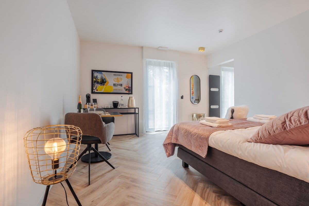 Un dormitorio moderno con cama, escritorio y silla.