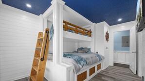 A bunk bed room with a wooden ladder, white walls, and a ceiling with a star pattern. - Centrally Located Beach Bungalow (Myrtle Beach)