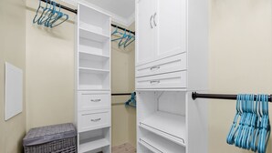A walk-in closet with open shelves, a hanging rod, and a laundry basket. - Centrally Located Beach Bungalow (Myrtle Beach)