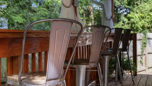 A wooden deck with metal chairs and a table. - Centrally Located Beach Bungalow (Myrtle Beach)