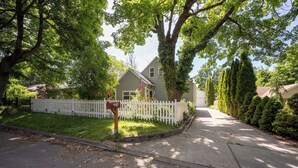 A residential street with a house, white picket fence, and mailbox. - Peaceful home in downtown CDA, 4 bed/2 bath!  Enjoy the sun on the private deck! (Coeur d'Alene)