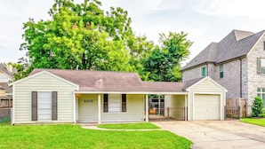A single-story house with a garage, a covered porch, and a number '6609' on the front.