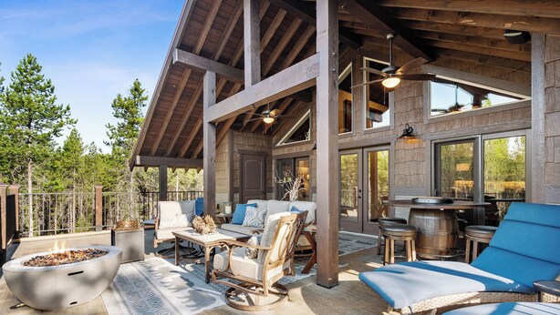 A spacious outdoor patio with a fire pit, seating area, and a bar. - 2 Miles to Going-to-the-Sun Road - Glacier NP – 8 Private Wooded Acres – Hot Tub (West Glacier)