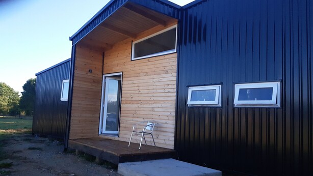 A modern, compact building with a wooden exterior and a metal door. - Cabin near Frutillar Lake Llanquihue (Casma)