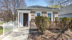 A two-story house with a front porch, a small garden, and a mailbox. - Check It Out! Great Location Large Priv w/Parking (Dubuque)