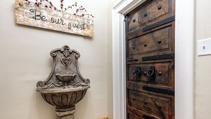 A rustic wooden door with a metal handle and a decorative sign above it that reads "Be our guest." - Check It Out! Great Location Large Priv w/Parking (Dubuque)
