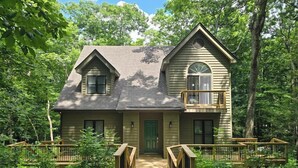 A two-story house with a front porch and a balcony, surrounded by trees. - The Getaway at Wintergreen Resort (Wintergreen Resort)