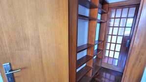 A wooden door leading to a hallway with a built-in wooden shelving unit. - Lisboa belem   elite domum (Lisbon)