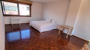 A bedroom with a bed, a small table, and a window. - Lisboa belem   elite domum (Lisbon)