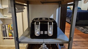 A kitchen counter with a toaster and a basket underneath. - 2 Blocks to UF Campus in Midtown & 10min Walk to Ben Griffin Stadium, Free Wi-Fi (Gainesville)