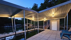 A covered outdoor area with a pool, a door, and a bench. - Norris Lakefront Retreat—Family Ready, Private Dock, Fire Pit, Screened Porch (LaFollette)