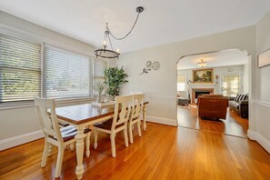 Relax in the living area with a leather sofa, dining table, and fireplace.
