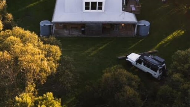 An aerial view of a house with a large front yard, surrounded by trees. - Woodlands - Secluded Rustic Cottage Near Great Ocean Road (Port Campbell)