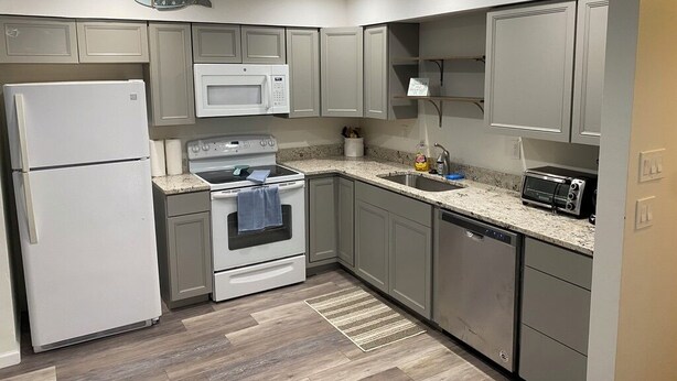 A compact kitchen with a refrigerator, microwave, stove, oven, and dishwasher. - Beachside 1/1 apartment just steps from beautiful Saint Augustine Beach (St. Augustine)