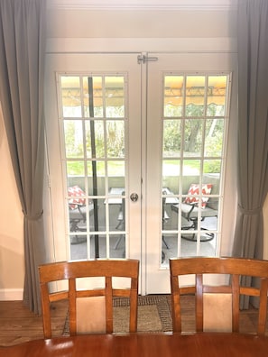 Enjoy the serene view from the patio, accessible through the double doors.