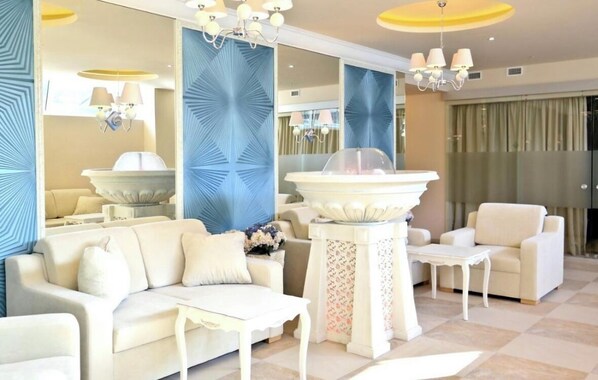 A spacious living room with a white sofa, a coffee table, and a decorative fountain. - L. Giros g. 15 (Vilnius)