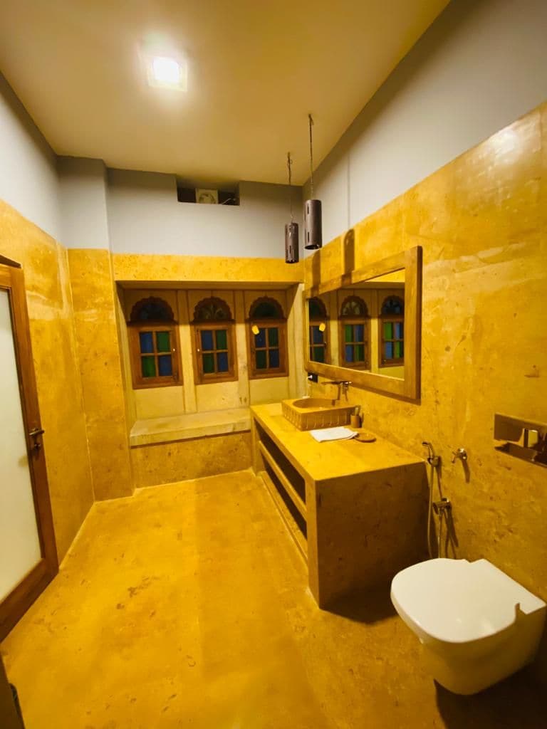 A bathroom with a sink, mirror, and toilet.