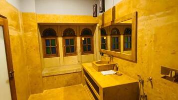 A bathroom with a sink, mirror, and toilet.