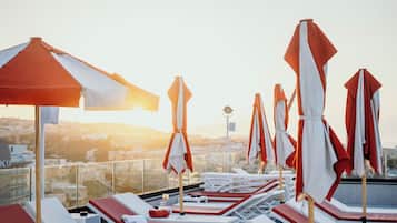 Seasonal outdoor pool, open 10:00 AM to 7:00 PM, pool umbrellas