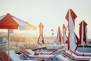 Seasonal outdoor pool, open 10:00 AM to 7:00 PM, pool umbrellas