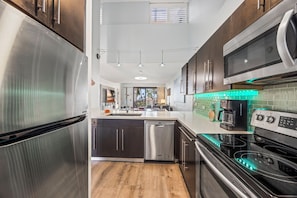 A modern kitchen with stainless steel appliances, a dishwasher, and a built-in oven.