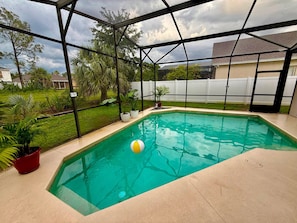 A rectangular indoor swimming pool with clear water, surrounded by a metal frame structure. - Grand Family House With Private Pool Near Disney Parks (Davenport)