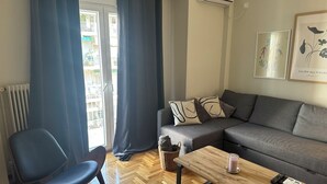 Un salon moderne avec un canapé gris, une table basse en bois et un fauteuil bleu.
