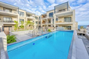 A modern apartment complex with a swimming pool, balconies, and a view of the sea. - Esplanade Hermanus (Hermanus)