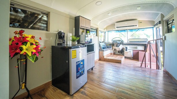 A compact kitchen with a refrigerator, microwave, and sink.