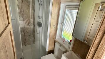 Shower, hair dryer, soap, toilet paper