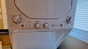 A front-loading washing machine with a control panel featuring multiple settings. - Studio, perfect for students on rotation at Oregon Health & Sciences University. (Portland)