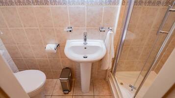 Ein Badezimmer mit Waschbecken, Toilette und Dusche.