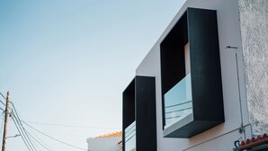 A modern building with large windows and a white facade.