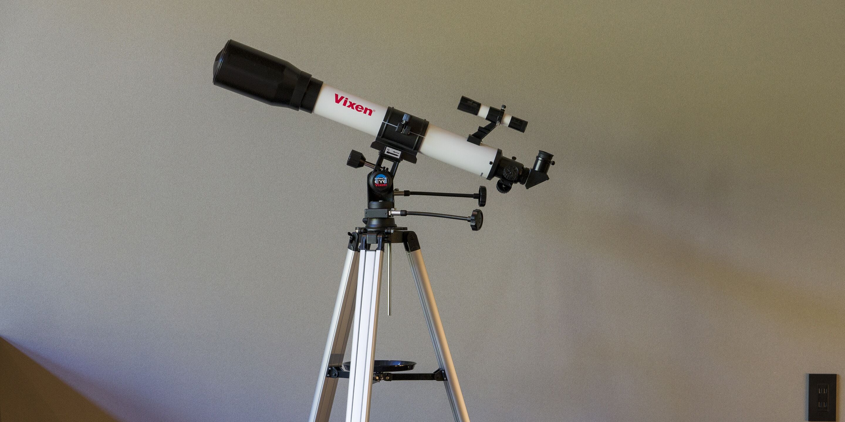 A Vixen telescope mounted on a tripod.