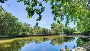 A calm water body surrounded by lush greenery and trees. - Mas provençal with tennis court, swimming pool and games and sports room (Velaux)