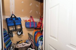 A storage area with a cart, bags, and various items. - Tranquil Waters, OceanPines, 3 br, Dog Friendly (Ocean Pines)