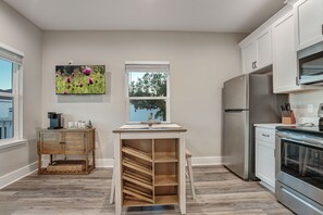 Prepare meals in the fully equipped kitchen with a refrigerator, oven, and ample counter space.