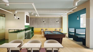A modern kitchen with a pool table, bar seating, and a dining area with tables and chairs. - Coleman Court Summer Accommodation (Cork)