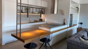A modern kitchen with a central island, pendant lighting, and a built-in oven. - Athens Market Iconic Loft, Stunning Acropolis View (Athens)