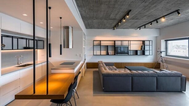 A modern kitchen with a built-in island, a seating area with a sofa and chairs, and a large window providing natural light. - Athens Market Iconic Loft, Stunning Acropolis View (Athens)