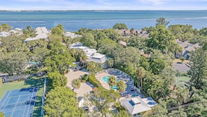A residential area with houses, a swimming pool, and a tennis court. - Beach Castle Resort, Pool, Private Beach! (Longboat Key)